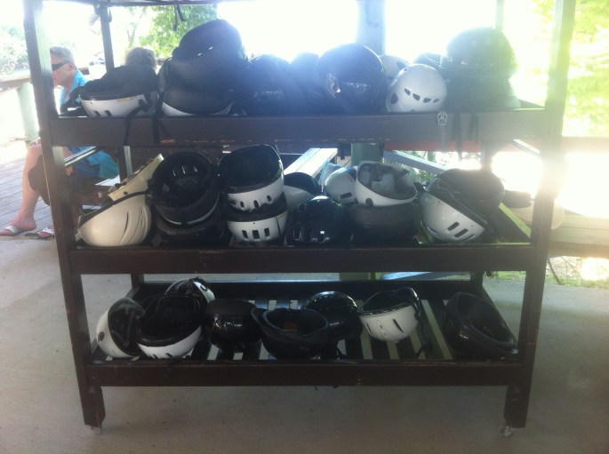 The helmet rack where everyone deposits their helmet and then the next group grabs one before they are called to get on their horse.
