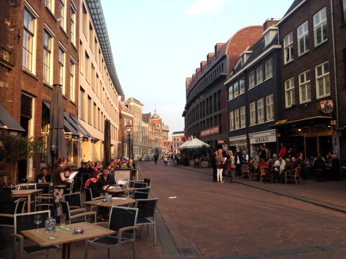 A typical street in Haarlem is filled with activity.