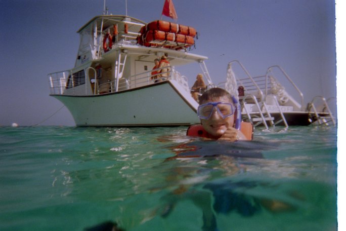 My partner with the boat in the background.