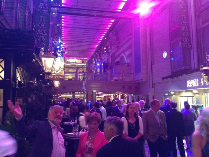 Formal night promenading on the Royal Promenade of the Royal Caribbean Navigator of the Seas. 