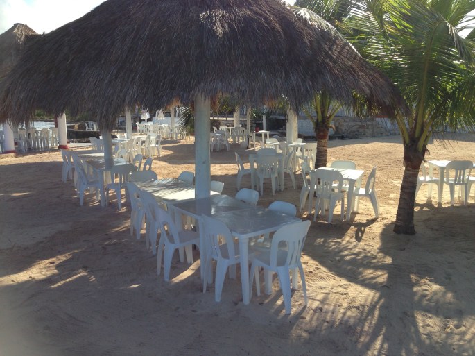 Palapas line the waterfront at the Playa Corona Beach Club in Cozumel, Mexico.