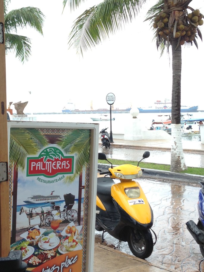 The view from Palmeras Restaurante Bar along the waterfront in San Miguel, Cozumel, Mexico. Across the street is the ferry terminal with service to Playa del Carmen.