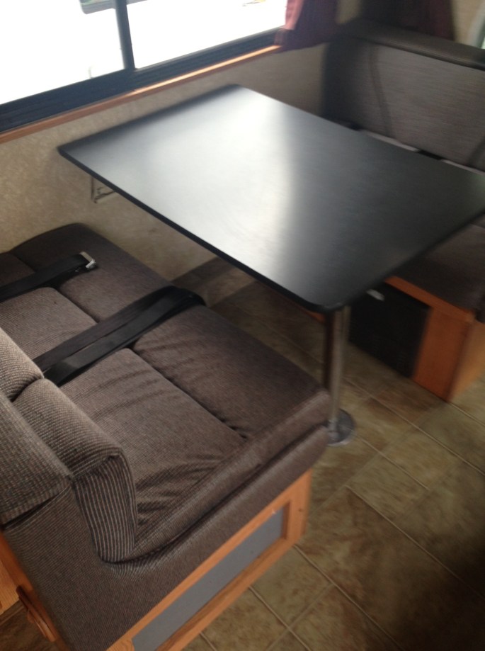 Plenty of room to play and eat in this RV while one of us drives through the country.  For families, this folds into a double bed and there is ample storage under each seat.